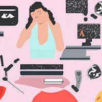 a woman is sitting at a desk with a lot of things around her